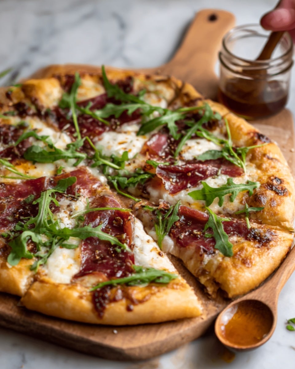 A close-up of a rustic pizza with a thick golden crust, topped with melted cheese spread unevenly, layers of thin dark red cured meat, and bright green fresh arugula leaves scattered on top, some cheese bubbling and slightly browned. The pizza is shown on a wooden board with a woman's hand holding a small wooden spoon in a glass jar near it, all set on a white marbled surface. photo taken with an iphone --ar 4:5 --v 7