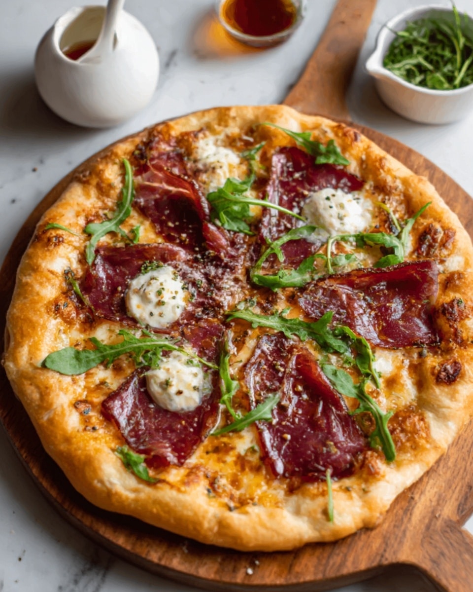 A round pizza with a golden-brown crust that looks soft and slightly puffy. On top, there are five large pieces of thin, dark red cured meat spread evenly. Between these, dollops of white, creamy cheese are melted with a slightly bubbly surface. Bright green fresh arugula leaves are scattered on the pizza, adding a pop of color. The pizza is placed on a wooden board over a white marbled surface, with a white container of sauce and some herbs in the background. Photo taken with an iphone --ar 4:5 --v 7