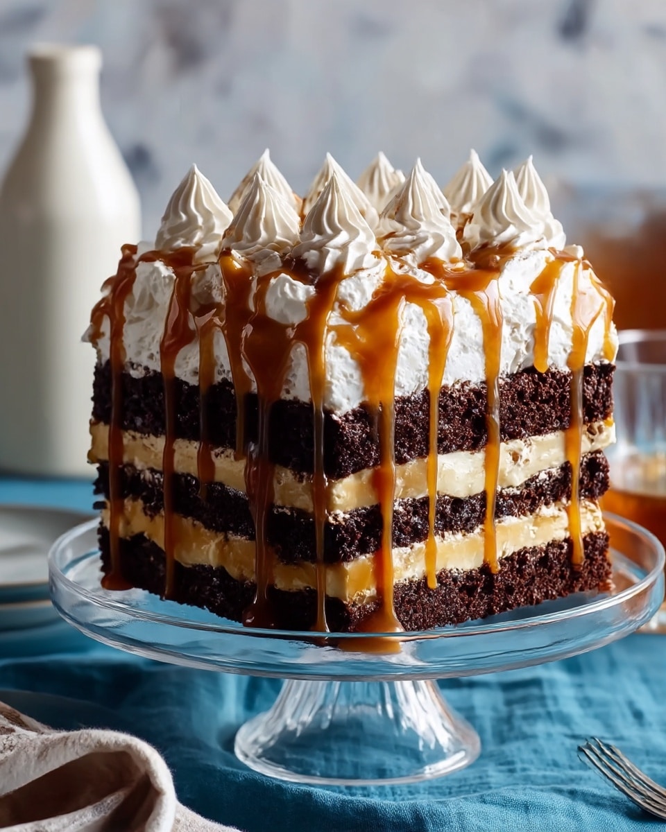 The dessert is a multi-layered square cake on a clear glass cake stand with a textured base. The cake has five visible layers starting with a dark, moist chocolate brownie base, followed by layers of sliced bananas covered by a thick caramel and chocolate sauce layer. Above that, a rich dark chocolate layer, then a thick white whipped cream layer topped with multiple dollops of whipped cream arranged in rows. The whipped cream dollops are drizzled with caramel sauce that also drips down the sides of the cake. The background includes blurry bottles, and the surface beneath the cake stand features a blue cloth on a white marbled texture. photo taken with an iphone --ar 4:5 --v 7