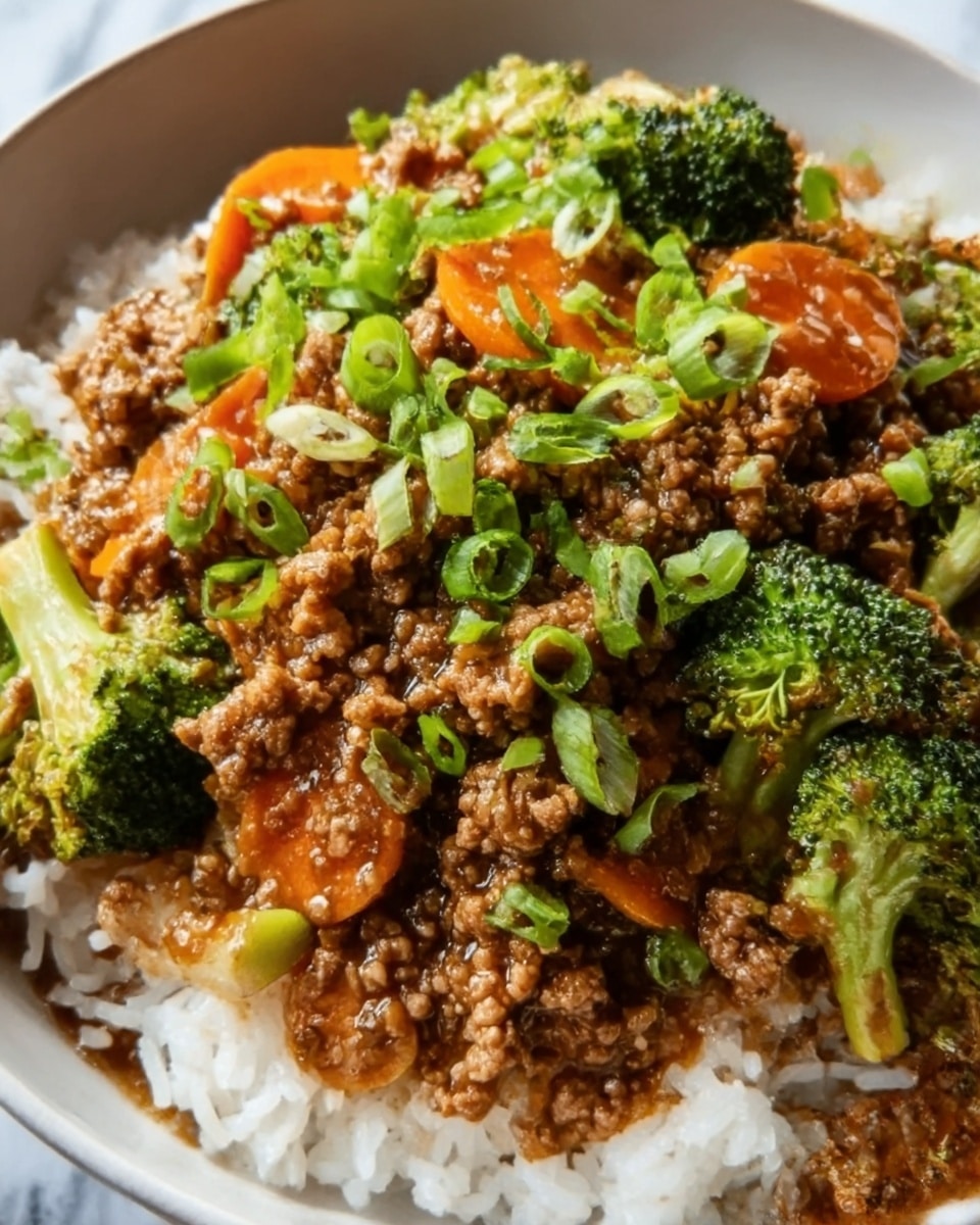 A close-up of a white bowl filled with steamed white rice at the bottom, topped with ground meat cooked in a rich brown sauce mixed with orange carrot slices and soft green broccoli florets. Bright green chopped scallions are sprinkled evenly over the top, adding a fresh contrast. The textures contrast between the fluffy rice, tender vegetables, and saucy meat. The bowl sits on a white marbled surface. photo taken with an iphone --ar 4:5 --v 7