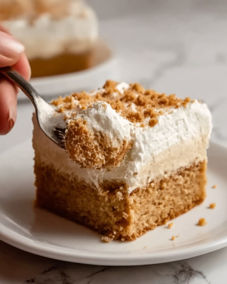 The image shows a close-up of a square slice of cake with three visible layers. The bottom layer is a soft, light brown cake with a moist texture, slightly crumbly. Above it is a creamy, caramel-colored filling layer that looks smooth and rich. The top layer is a thick, fluffy white cream with some crumbs sprinkled on it, adding a slightly rough texture. The cake sits on a white marbled surface with some crumbs scattered around it, giving a casual look. photo taken with an iphone --ar 4:5 --v 7
